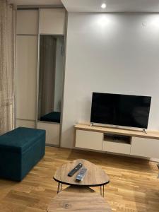 een woonkamer met een tv en een bank en een tafel bij ApartmanM&M in Banja Luka