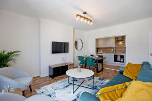a living room with a couch and a table at Marvelous Flat in Earls Court - London in London