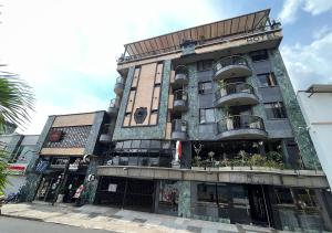 a building with balconies on the side of it at Hotel D' Leon in Bucaramanga