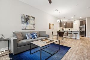 a living room with a couch and a table at LUX 2 BED DESERT RIDGE 2 HEATED POOLS GYM in Phoenix