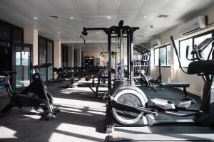 a gym with lots of treadmills and machines at Hotel Tano Guam in Tumon