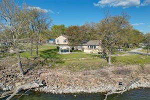 an aerial view of a house and a lake at Grand Lake Waterfront Home with Shared Boat Ramp! in Grove