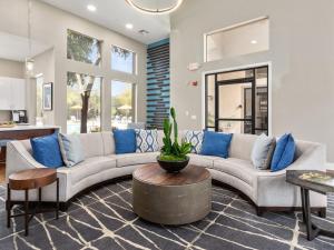 a living room with a large couch and blue pillows at Pure Suites 2 Bed N Scottsdale McDowell Mtn Ranch Gym Pool in Scottsdale