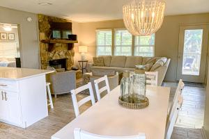 a kitchen and living room with a table and chairs at Sea Pine Cottage in St. George Island