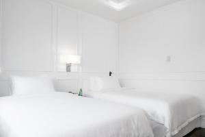 Postel nebo postele na pokoji v ubytování Hotel Tano Guam