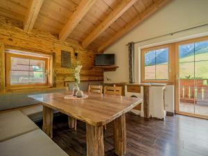 a living room with a wooden table in a cabin at Sommerstein in Maria Alm am Steinernen Meer