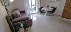 a living room with a couch and a table at Apartmani S&S in Stara Novalja