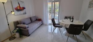 a living room with a couch and a table at Apartmani S&S in Stara Novalja +74 photos