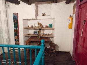 a room with a table and a red door at Hostal Arte Candelaria in Bogotá