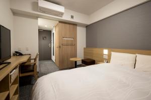 Ένα ή περισσότερα κρεβάτια σε δωμάτιο στο Dormy Inn Hiroshima Annex