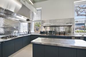 a large kitchen with blue cabinets and a counter top at The Pacific House in Sydney