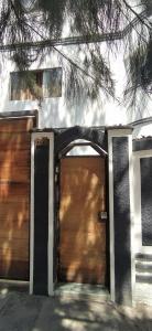 a house with two garage doors in front of it at Casa Moya Vallecito in Arequipa