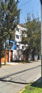 an empty street in front of a white building at Casa Moya Vallecito in Arequipa