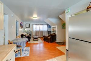 a kitchen and living room with a white refrigerator at Cozy Apartment in Fairbanks about 2 Mi to Downtown! in Fairbanks