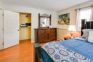 - une chambre avec un lit, une commode et un miroir dans l'établissement Cozy Apartment in Fairbanks about 2 Mi to Downtown!, à Fairbanks