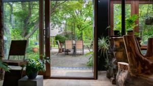 an open door to a patio with a table and chairs at Dreamers Mt Beauty in Mount Beauty