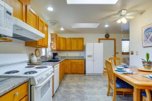 a kitchen with a table and a white refrigerator at Cozy Las Cruces Home - 2 Mi to New Mexico State! in Las Cruces