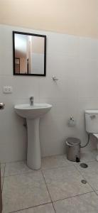 a bathroom with a sink and a toilet at Casa Moya Vallecito in Arequipa