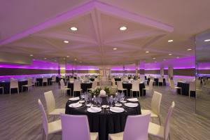 un salón de banquetes con mesas, sillas e iluminación púrpura en Meliá Palma Marina, en Palma de Mallorca 110 fotos más