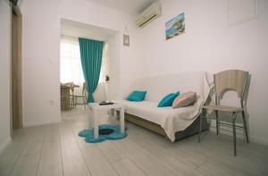 a bedroom with a bed and a chair and a table at Apartments with a parking space Kastel Kambelovac, Kastela - 21071 in Kaštela