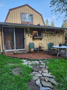 a house with a patio with a table and chairs at Scott Creek Farm in Happy Valley