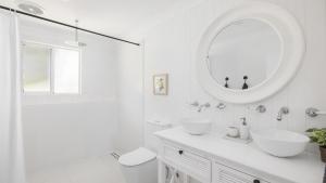 a white bathroom with two sinks and a mirror at Soul Bliss at Shoal Bay in Shoal Bay +32 photos