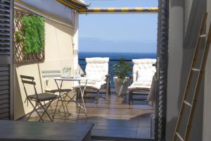 a balcony with chairs and a table with a view at EDEN RENTALS Caletillas Ocean Views in Candelaria