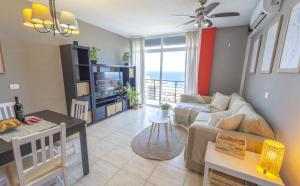 a living room with a couch and a table at EDEN RENTALS Caletillas Ocean Views in Candelaria