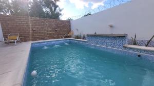 a swimming pool with a ball in the water at Departamentos Salvador in Termas de Río Hondo