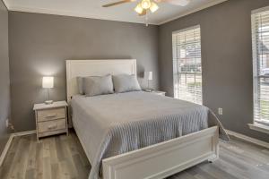 a bedroom with a bed and a ceiling fan at New Orleans Home with Backyard Near French Quarter in New Orleans