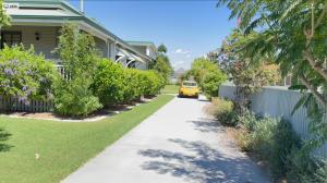 a yellow car is driving down a driveway at Area51 Warwick in Warwick