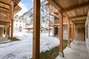 a view from inside a building in the snow at Mirtillo Blu Family Apartment in Alagna Valsesia