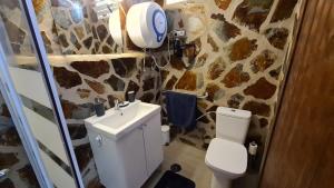 a bathroom with a toilet and a sink at Oasis house in Nazaret