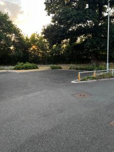 an empty parking lot with trees in the background at North Colchester Homestay in Colchester