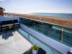 a balcony with a view of the beach at Dreamcatcher in South Hayling