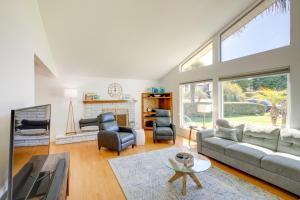 a living room with a couch and chairs and a fireplace at Lakefront Grover Beach Home about Walk to Ocean! in Grover Beach