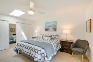 a bedroom with a bed and a chair at Lakefront Grover Beach Home about Walk to Ocean! in Grover Beach