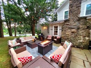 a patio with couches and a fire pit in a yard at Pump House Inn & Spa in Skytop