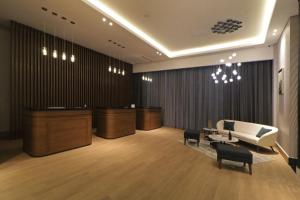 a lobby with a white couch and some chairs at Culiacan Marriott Hotel in Culiacán +103 photos