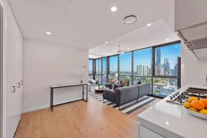 a kitchen and living room with a view of the city at Prime Located Luxe 2 BR Sky Home/Sensational Views in Brisbane