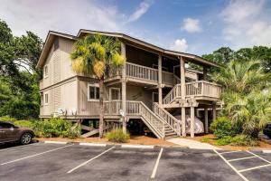 a large house with a staircase in a parking lot at Lagoon Villa 19 - Lagoon Lifestyle! Center of Wild Dunes! in Isle of Palms
