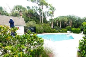 a swimming pool in a yard with trees at Lagoon Villa 19 - Lagoon Lifestyle! Center of Wild Dunes! in Isle of Palms