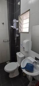 a bathroom with a toilet and a sink at My Home N2 @ Golden Hills Night Market in Cameron Highlands +43 photos