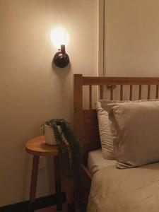 a table next to a bed with a lamp on the wall at 1-bedroom apartment in Uptown Waterloo in Waterloo
