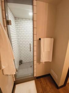 a bathroom with a walk in shower and a glass door at 1-bedroom apartment in Uptown Waterloo in Waterloo