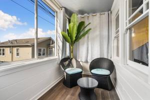 a balcony with two chairs and a table and a window at New 2BR 1BA Retreat With Modern Design in South San Francisco