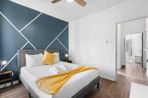 a bedroom with a large bed with a blue wall at New 2BR 1BA Retreat With Modern Design in South San Francisco