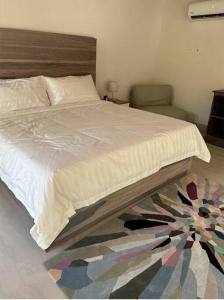 a bedroom with a large bed with a wooden headboard at Casa Kaiman - Apartment Vista in Nosara