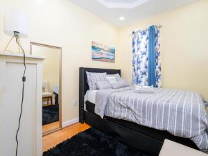 a bedroom with a bed and a mirror at A slice of paradise awaits you! in Brooklyn