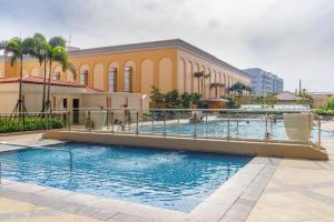 a large swimming pool in front of a building at Luxe in Venice in Manila